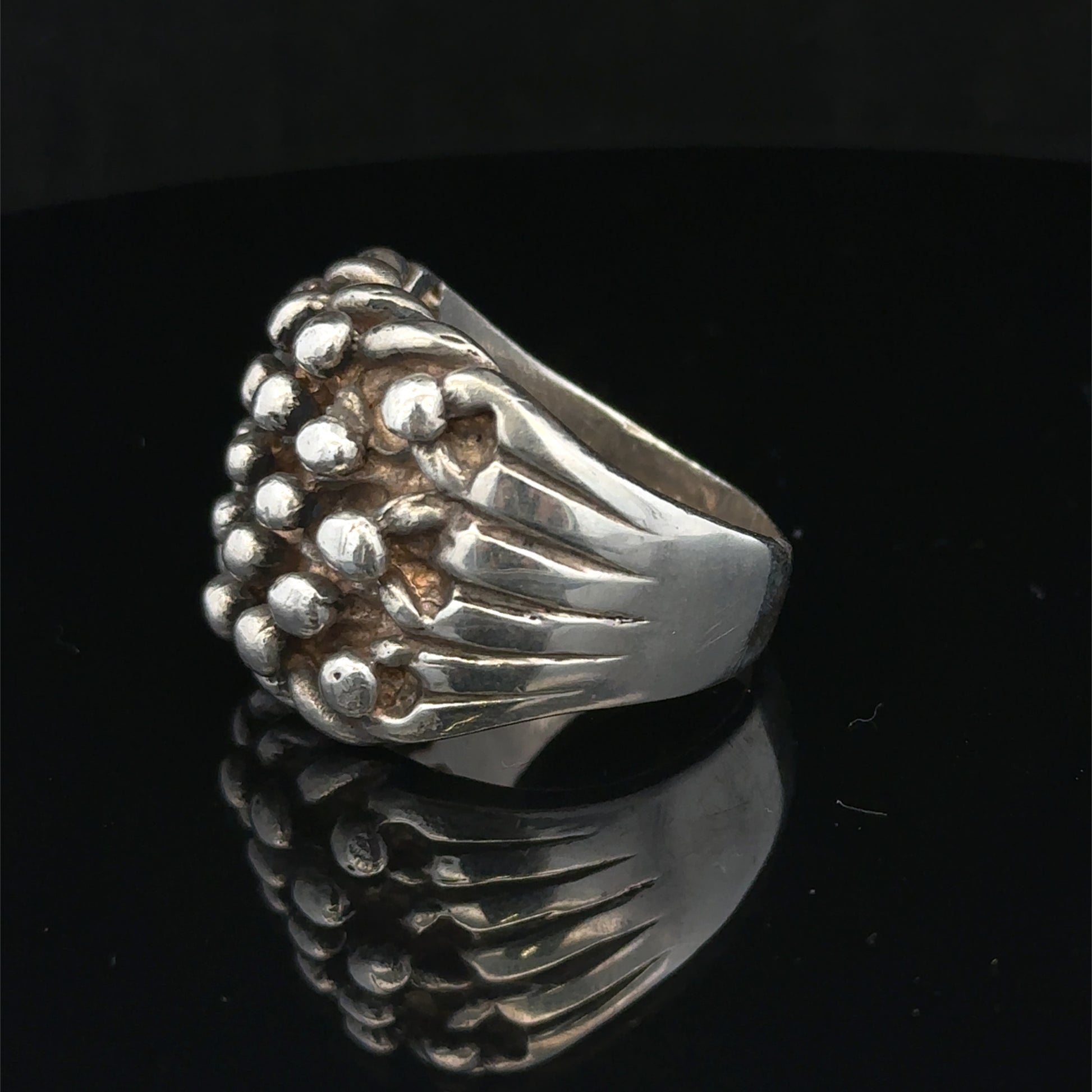 Silver keeper ring size Z1 by Reeves and Sons showing a polished silver ring with a smooth band and detailed craftsmanship.