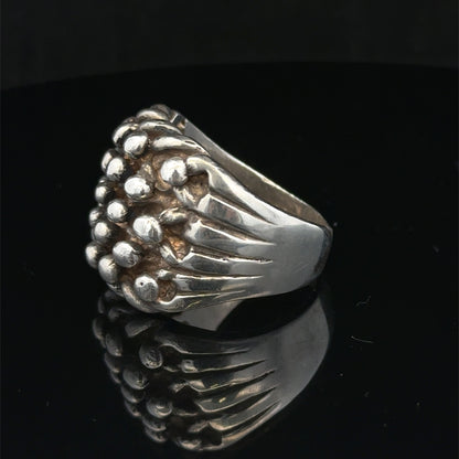 Silver keeper ring size Z1 by Reeves and Sons showing a polished silver ring with a smooth band and detailed craftsmanship.