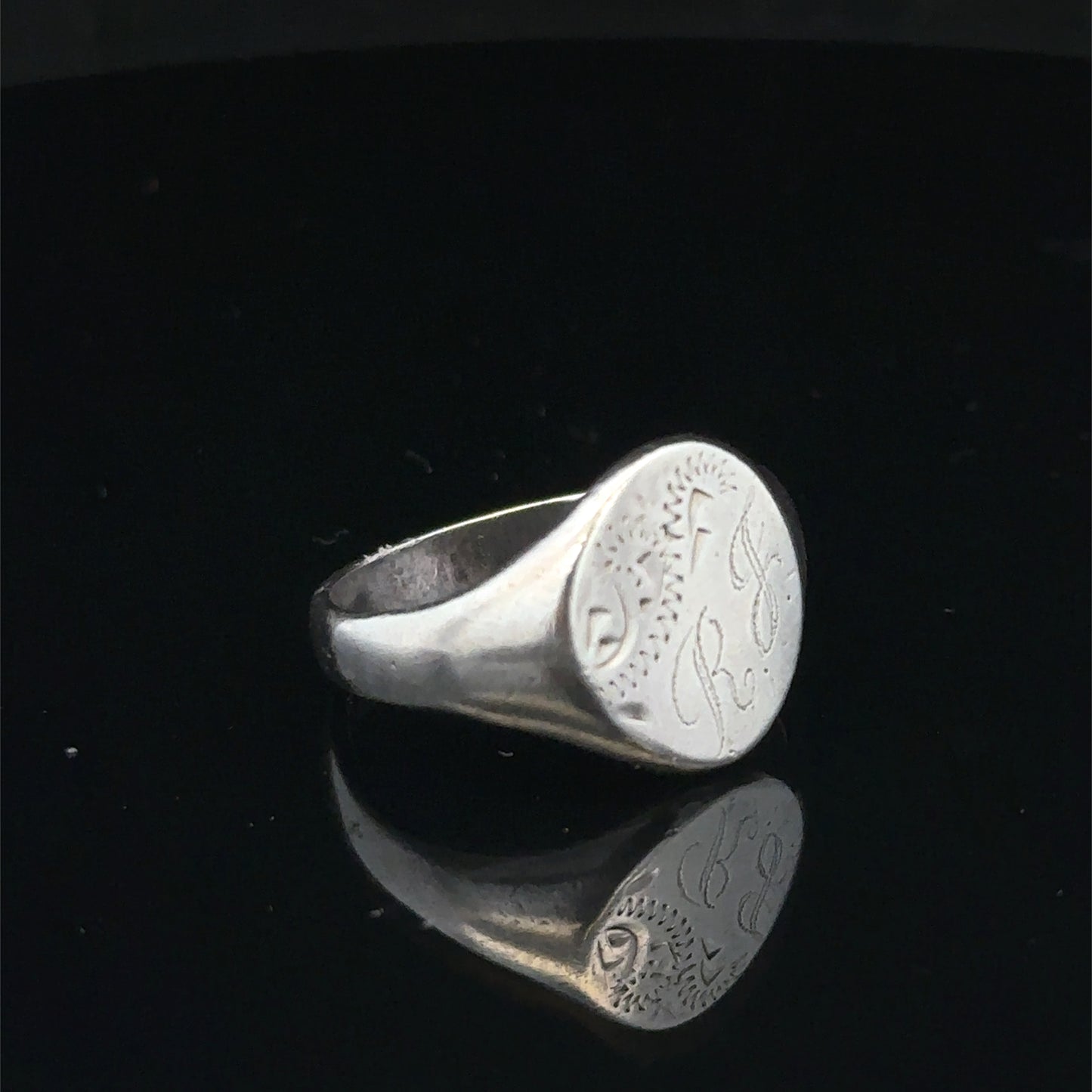 Silver signet ring from Reeves and Sons, size S1/2, featuring a polished band and classic design.