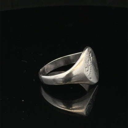 Silver signet ring by Reeves and Sons, size S1/2, featuring a smooth polished surface and classic design.