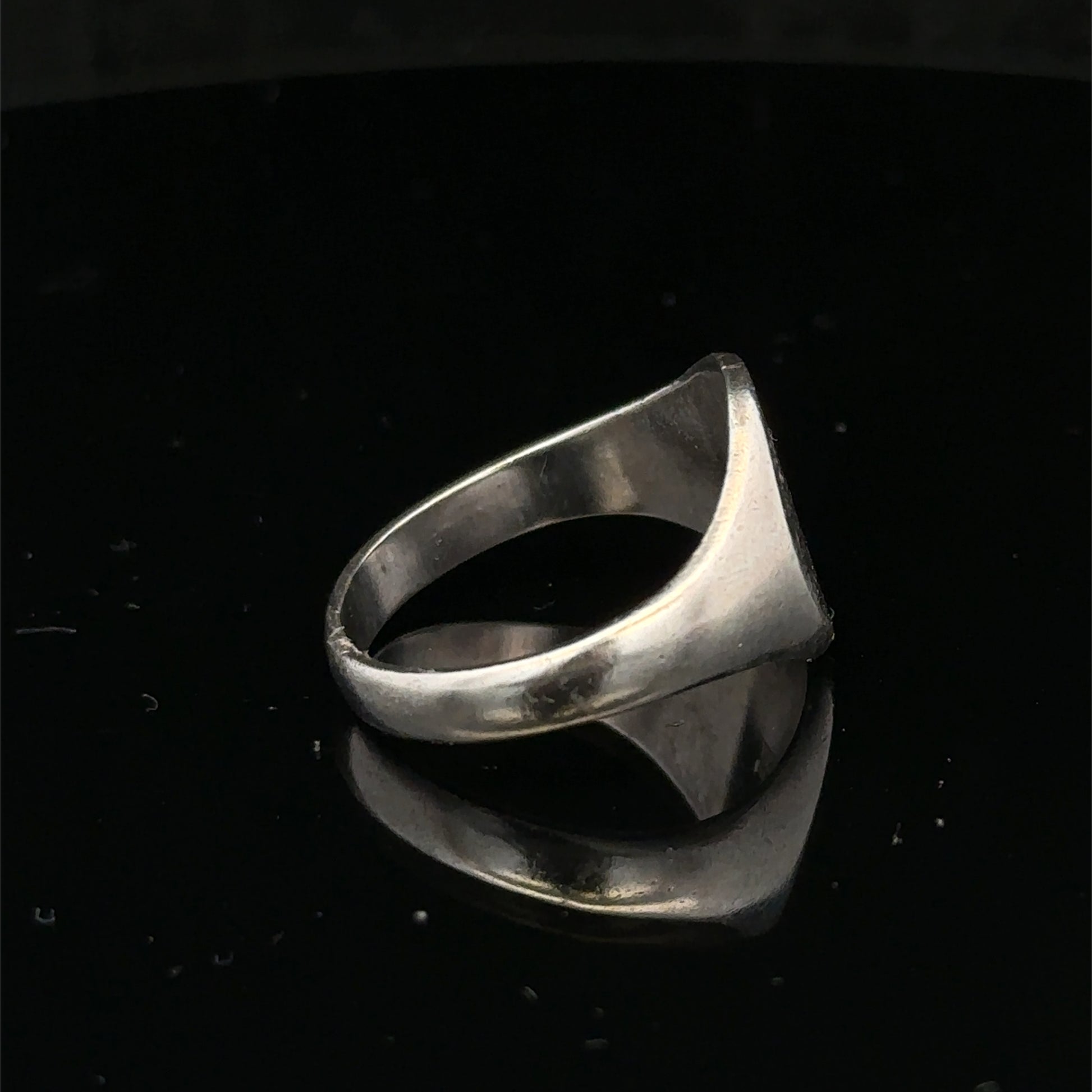 Silver signet ring with engraved face, size S1/2, by Reeves and Sons, displayed on a neutral background.