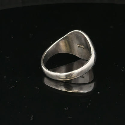 Silver signet ring by Reeves and Sons in size S1/2, featuring a polished smooth surface and classic design.