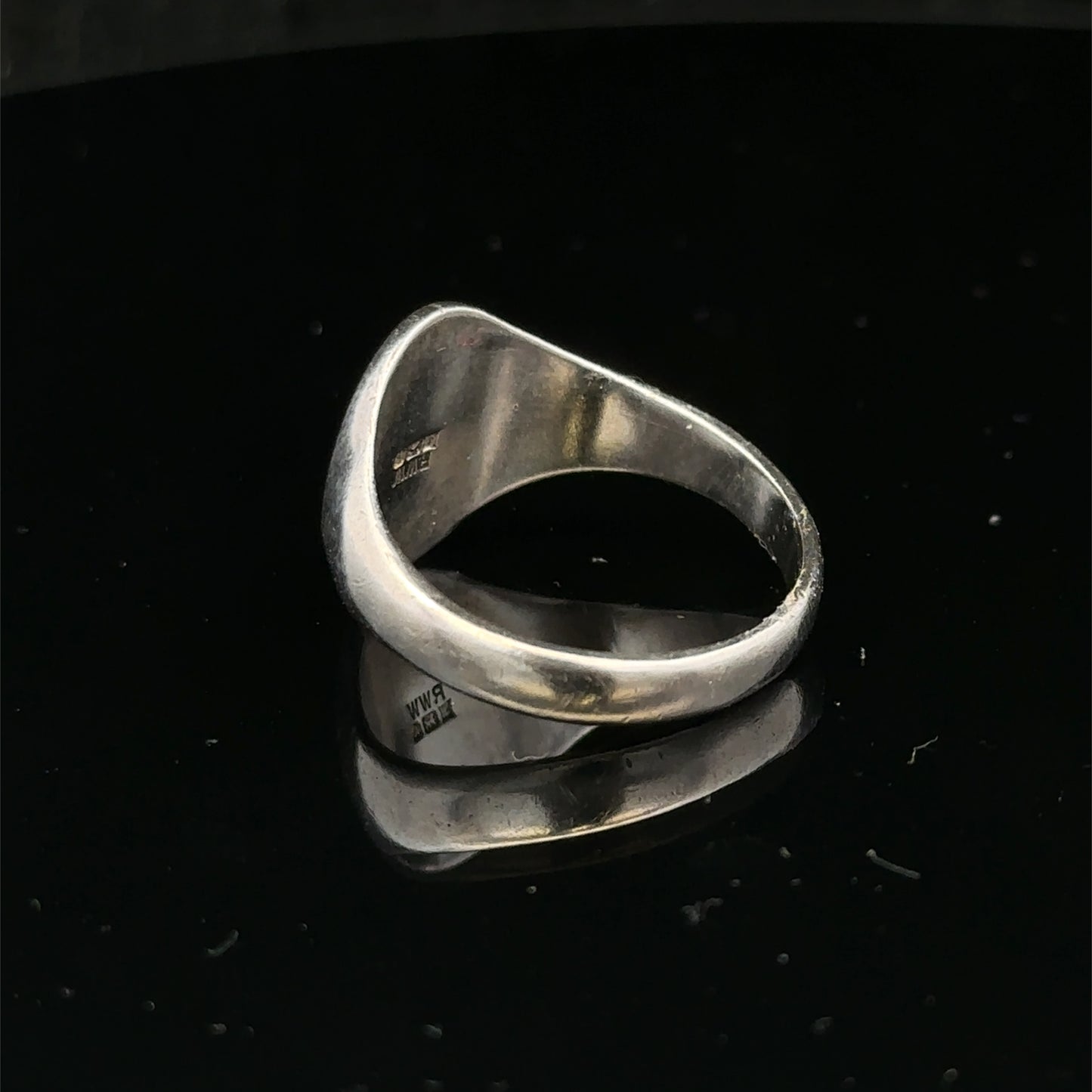 Silver signet ring by Reeves and Sons, size S1/2, featuring a smooth polished surface and classic design.