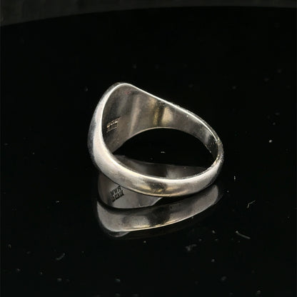 Silver signet ring by Reeves and Sons, size S1/2, featuring a smooth polished surface and classic design.