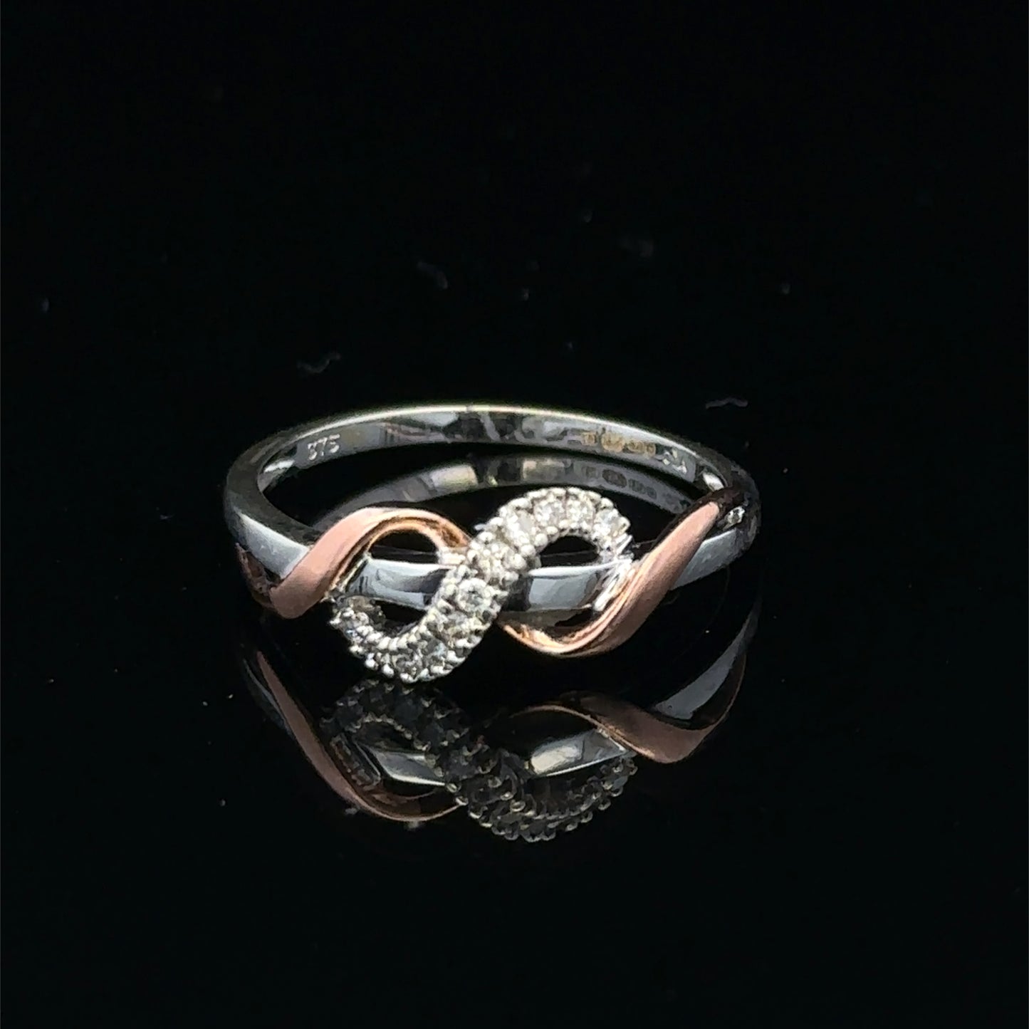 9ct white gold diamond ring in size M with sparkling diamonds, featuring a sleek design from Reeves and Sons.