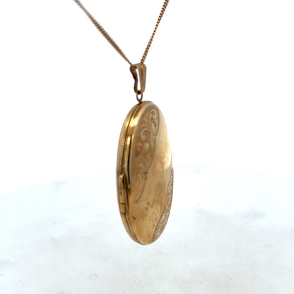 9ct yellow gold locket pendant by Reeves and Sons, 6.6g, showcasing a smooth, polished surface with intricate detailing.