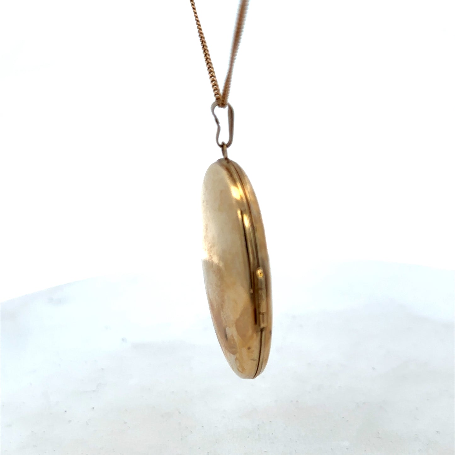 9ct yellow gold locket pendant with intricate design, weighing 6.6g, from Reeves and Sons, showcased against a neutral background.