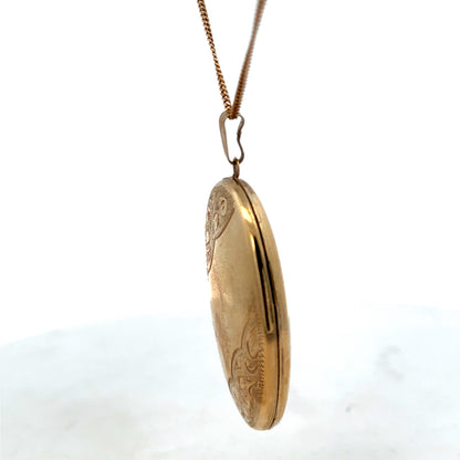 Reeves and Sons 9ct yellow gold locket pendant, 6.6g, classic oval design, detailed craftsmanship, jewelry accessory.