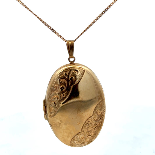 9ct yellow gold locket pendant with intricate design, Reeves and Sons brand, weighs 6.6g, displayed on a plain background.