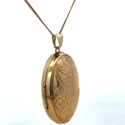 9ct yellow gold locket pendant by Reeves and Sons, showcasing a detailed design, weighing 6.3g, on a neutral background.