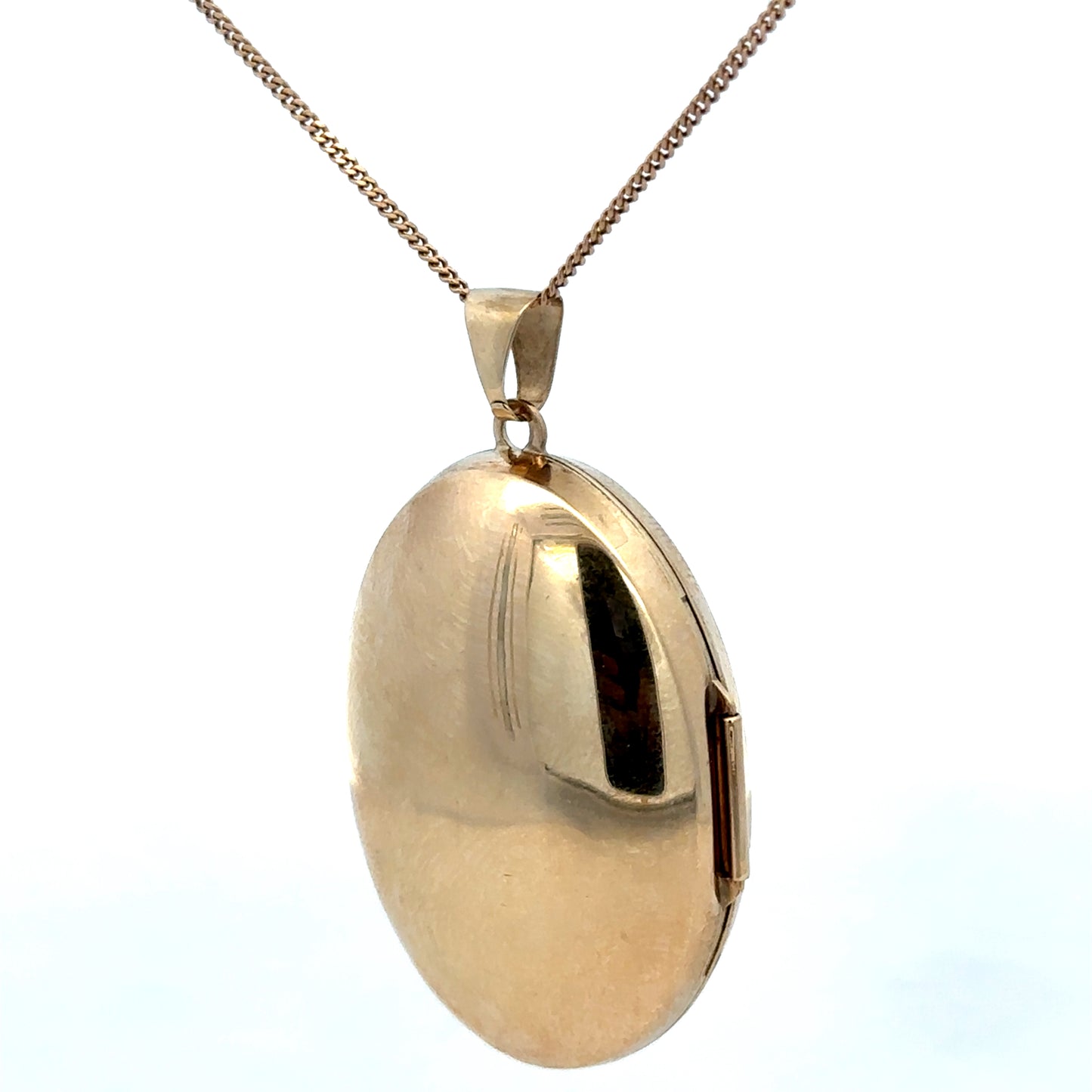 9ct yellow gold locket pendant with intricate design, weighing 6.3g, from Reeves and Sons, displayed against a neutral background.