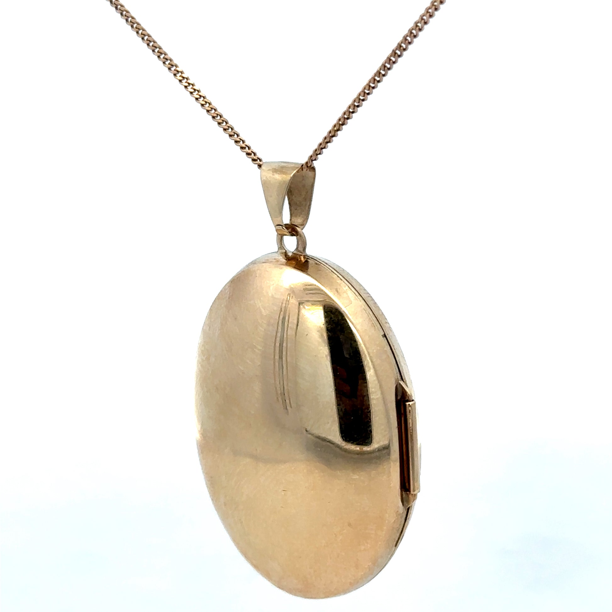 9ct yellow gold locket pendant with intricate design, weighing 6.3g, from Reeves and Sons, displayed against a neutral background.