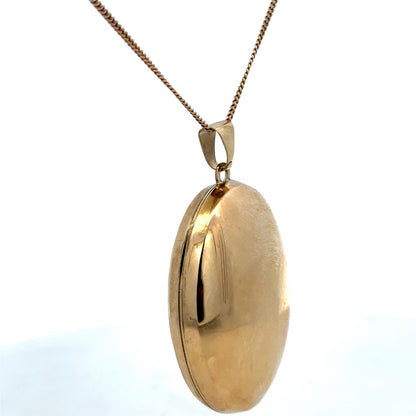 9ct yellow gold locket pendant by Reeves and Sons, featuring intricate design, weighs 6.3g, shown with detailed craftsmanship.