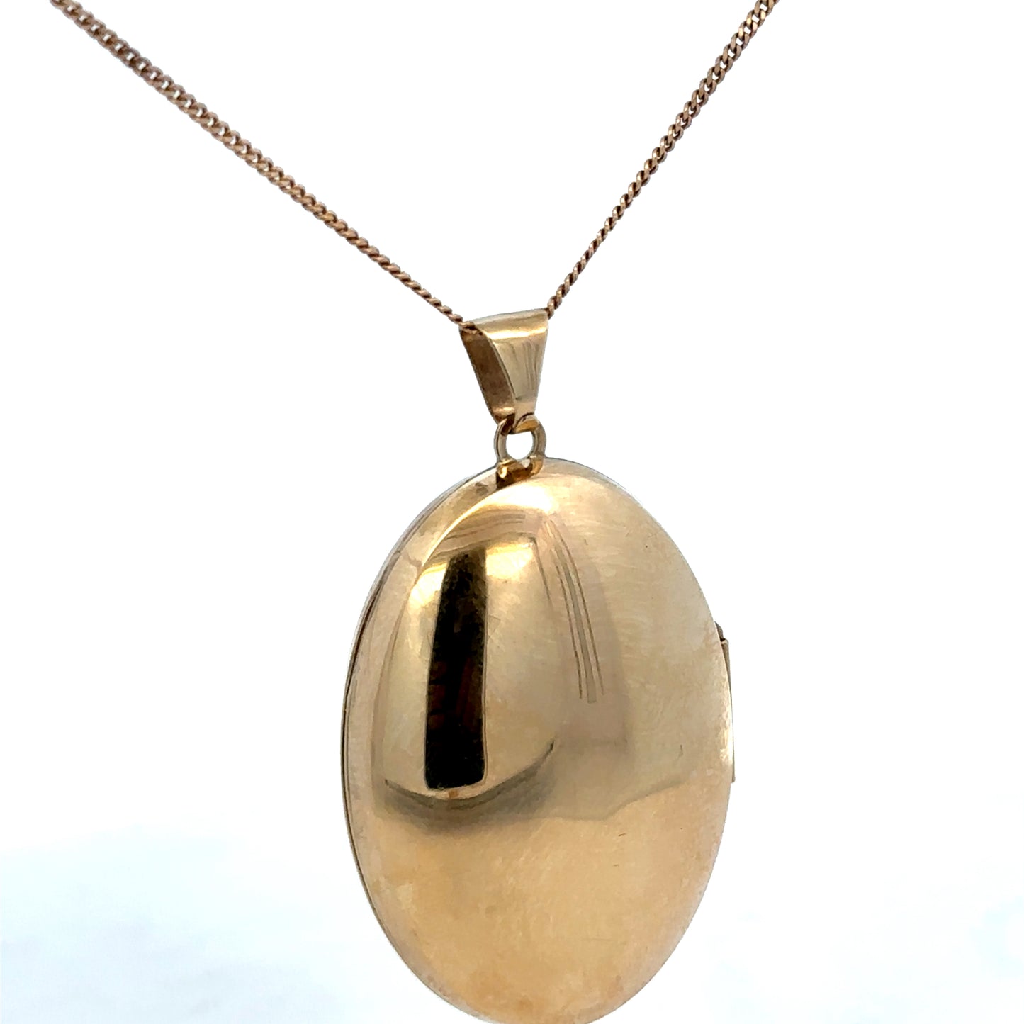 9ct yellow gold locket pendant with intricate design, weighing 6.3g, by Reeves and Sons, shown in close-up detail.
