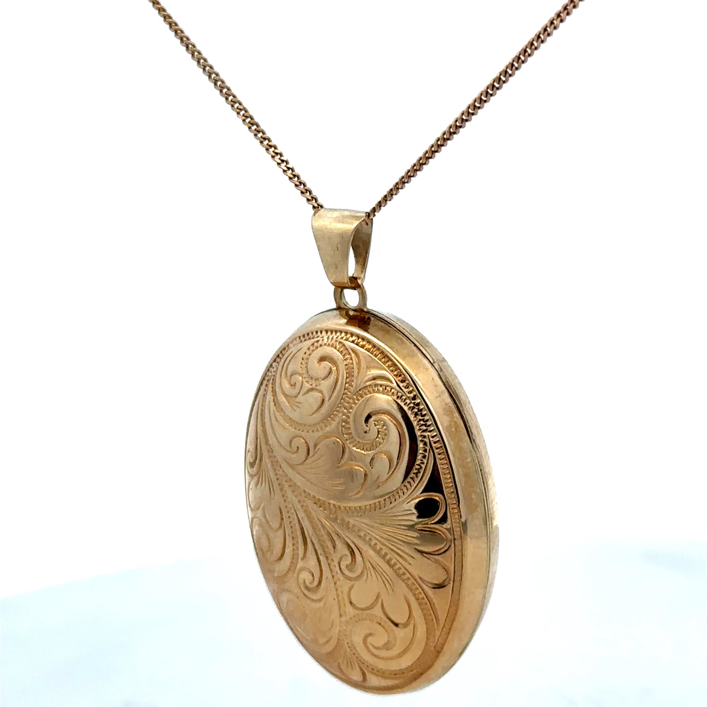 9ct yellow gold locket pendant by Reeves and Sons, 6.3g, showcasing a detailed, polished jewelry piece with a classic design.