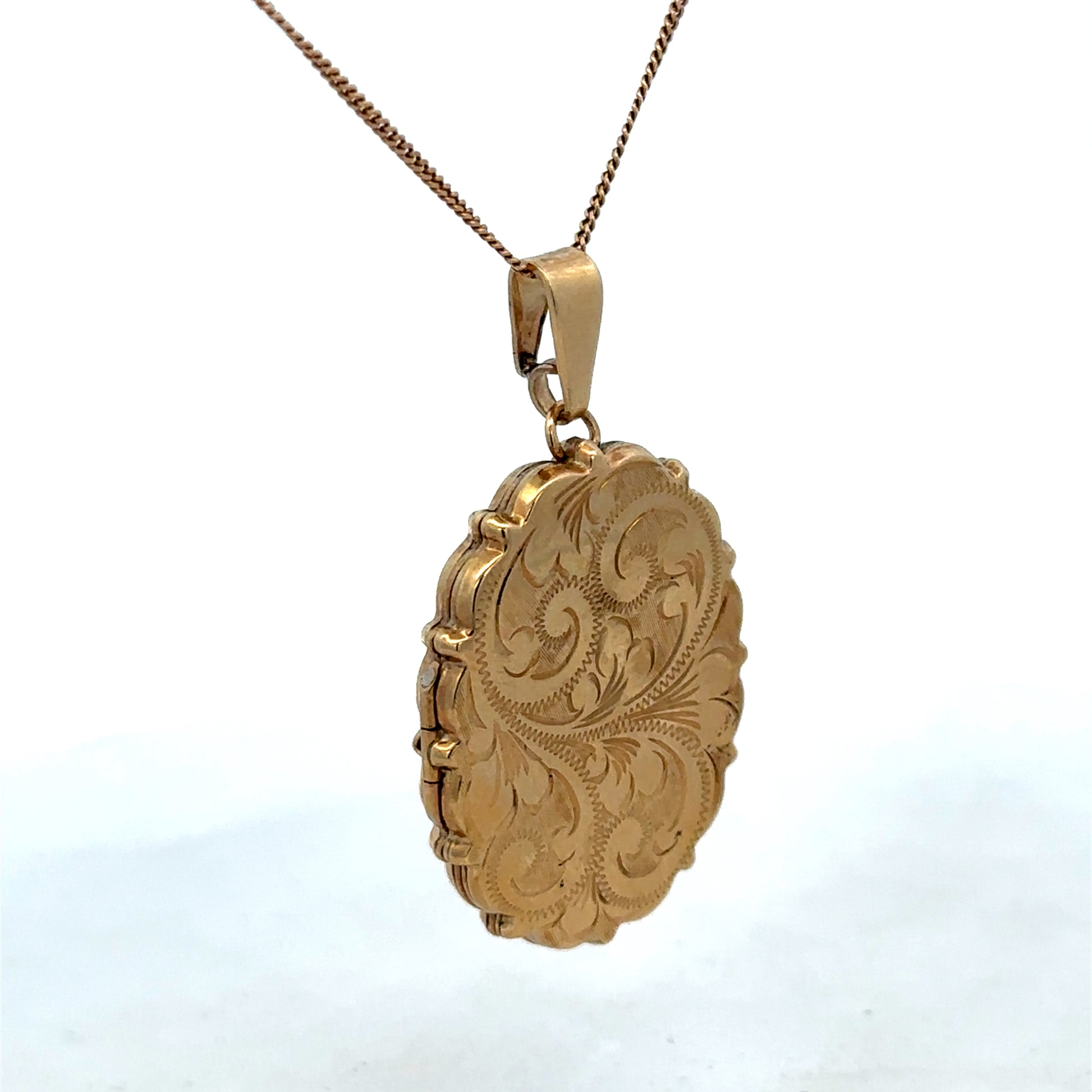 9ct yellow gold locket pendant by Reeves and Sons, showcasing a detailed design with a polished finish.