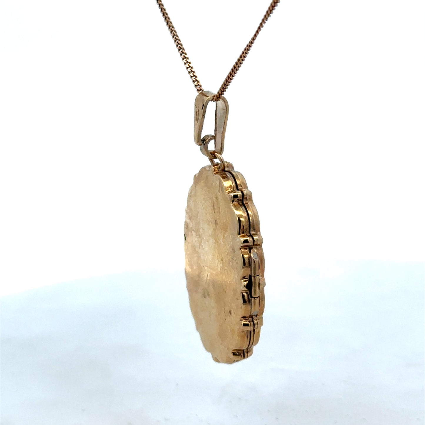 9ct yellow gold locket pendant by Reeves and Sons, showcasing a polished pendant with intricate detailing and a secure bail.