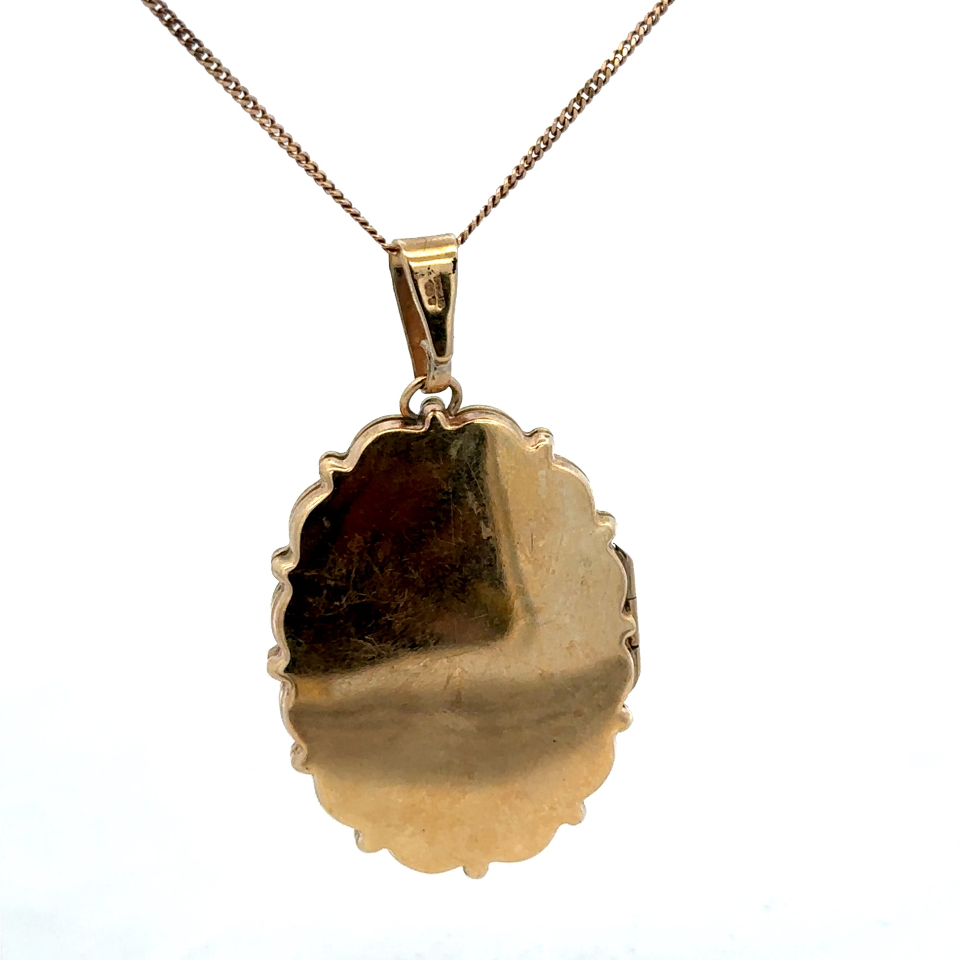 9ct yellow gold locket pendant by Reeves and Sons, featuring a detailed design, weighs 8.1g, with a polished finish and intricate craftsmanship.