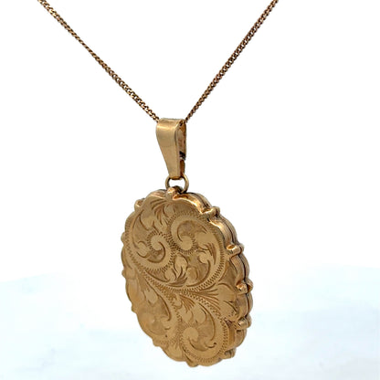 9ct yellow gold pendant locket from Reeves and Sons, 8.1g, featuring a detailed design, shown in a close-up image.
