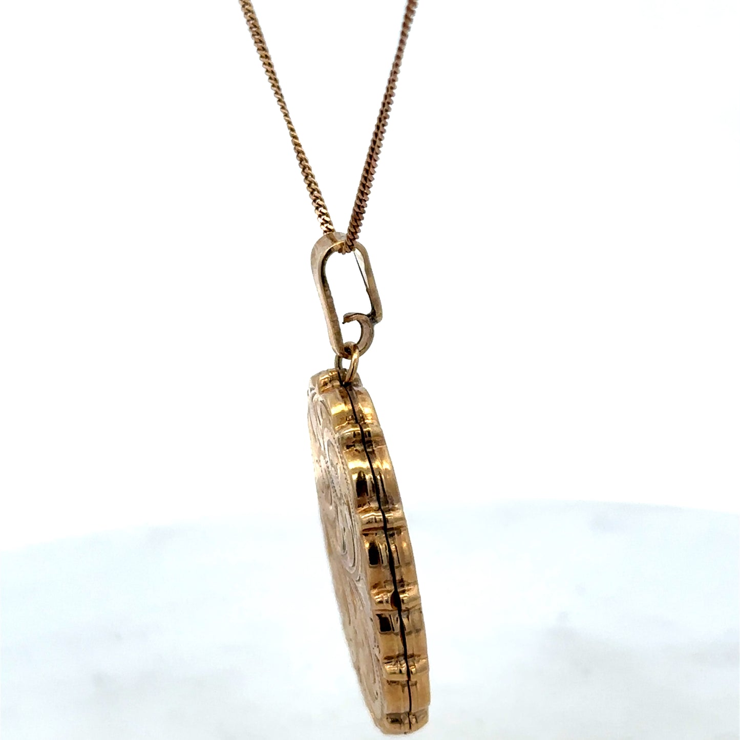 9ct yellow gold locket pendant by Reeves and Sons, showcasing a polished gold pendant with detailed craftsmanship.