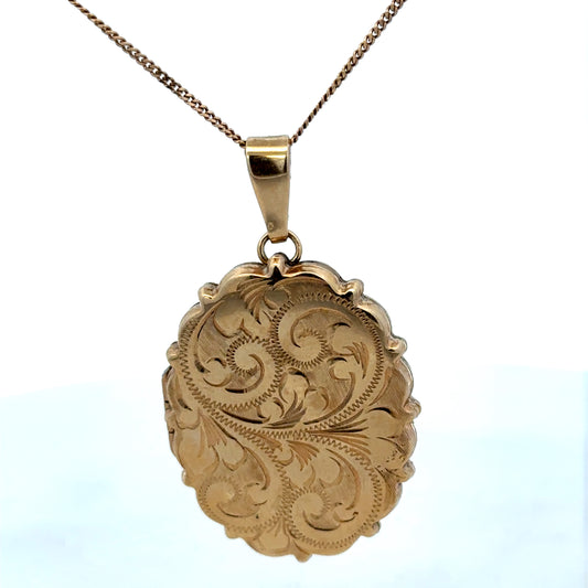9ct yellow gold locket pendant with intricate design, weighing 8.1g, by Reeves and Sons, shown with detailed craftsmanship.