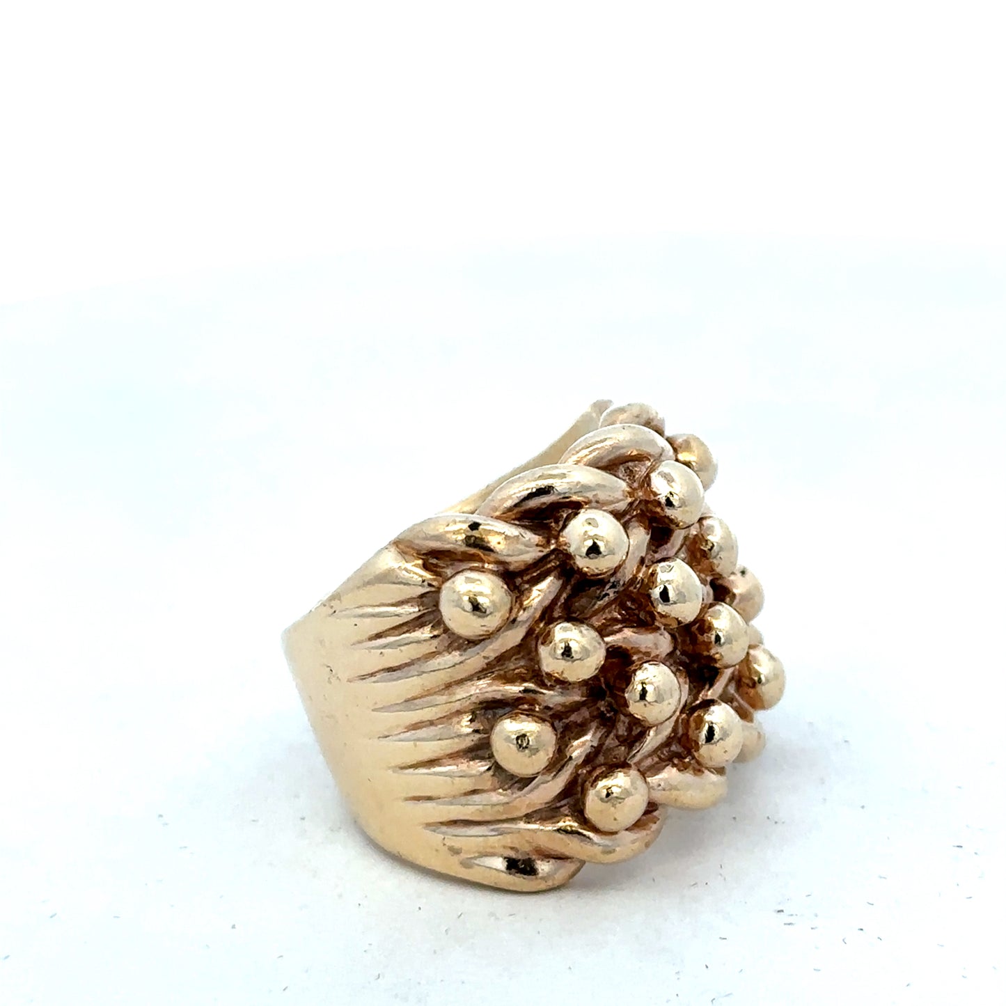 9ct yellow gold keeper ring in size Y by Reeves and Sons, close-up showing polished band and detailed craftsmanship.