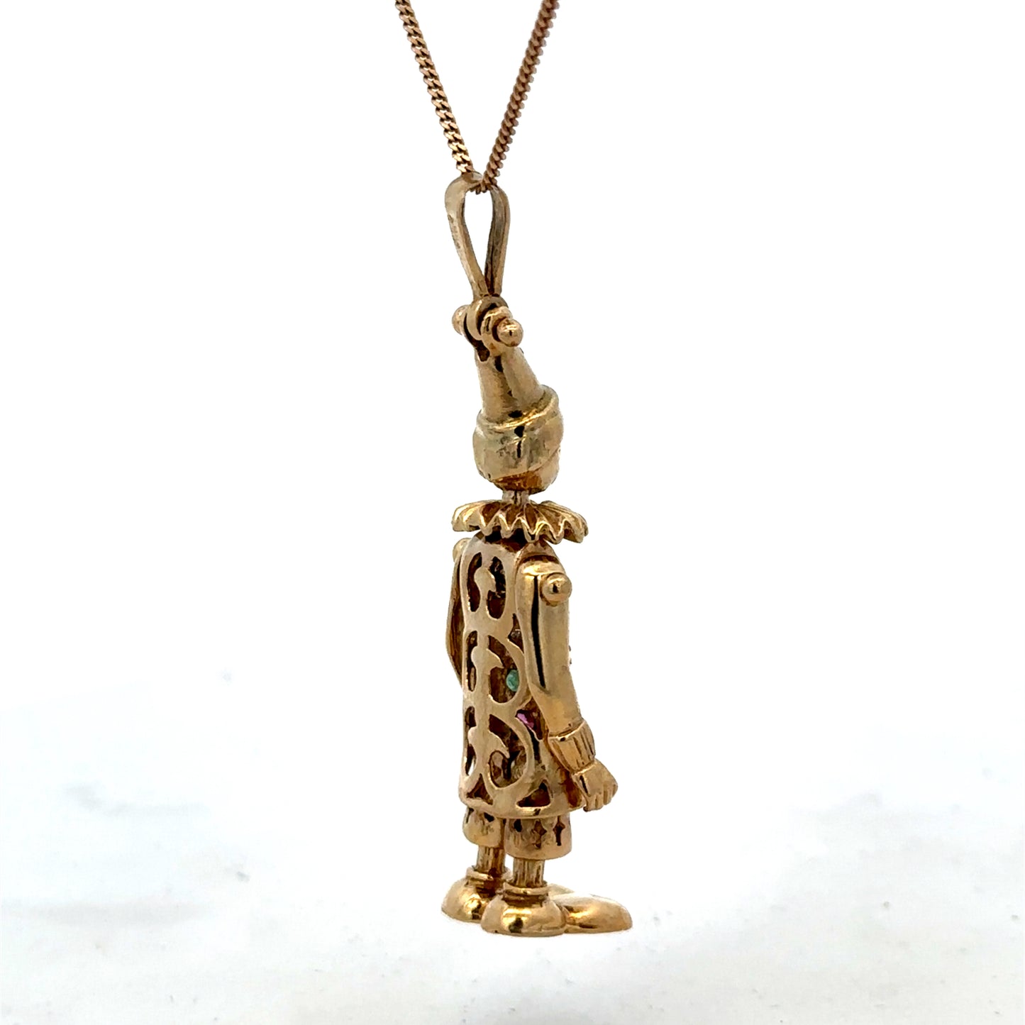9ct yellow gold clown pendant weighing 8.7g, detailed craftsmanship, shiny finish, and playful clown design by Reeves and Sons.