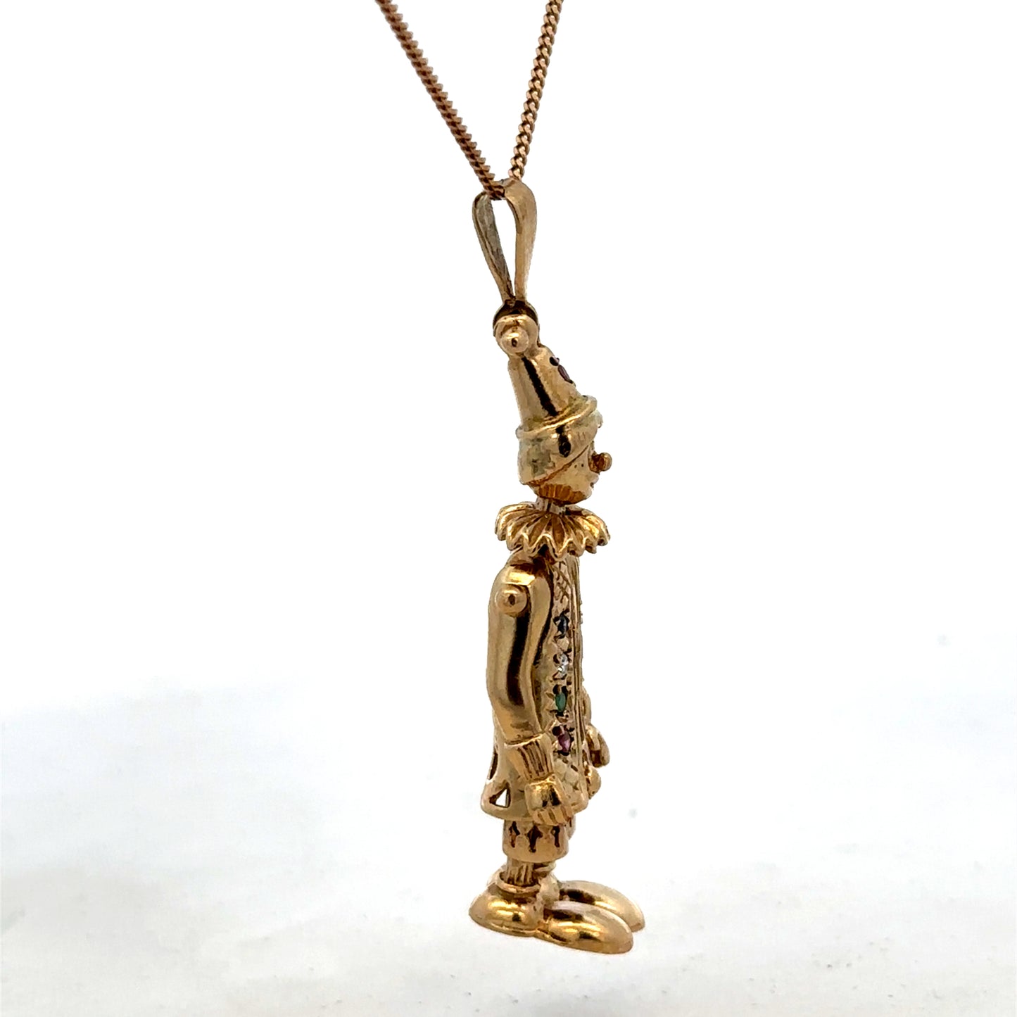 9ct yellow gold clown pendant by Reeves and Sons, detailed design, weighs 8.7g, shown against a plain background.