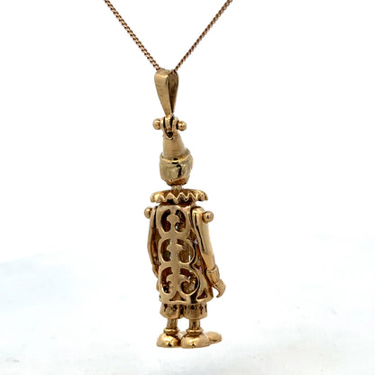 9ct yellow gold clown pendant weighing 8.7g, featuring detailed craftsmanship, from Reeves and Sons.