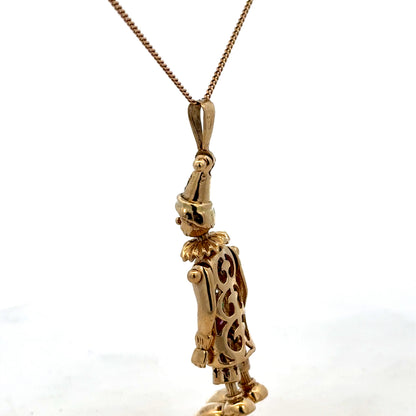 9ct yellow gold clown pendant weighing 8.7g, featuring a detailed clown design, from Reeves and Sons.