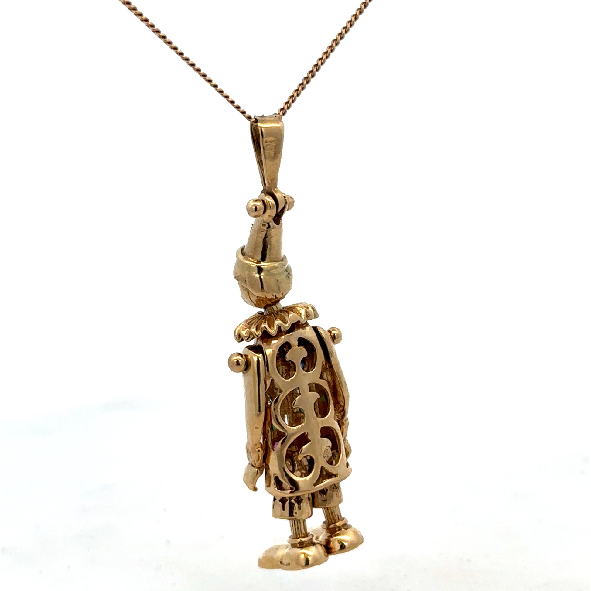 9ct yellow gold clown pendant weighing 8.7g, detailed design by Reeves and Sons, featuring a playful clown figure.