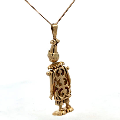 9ct yellow gold clown pendant weighing 8.7g, detailed design by Reeves and Sons, featuring a playful clown figure.