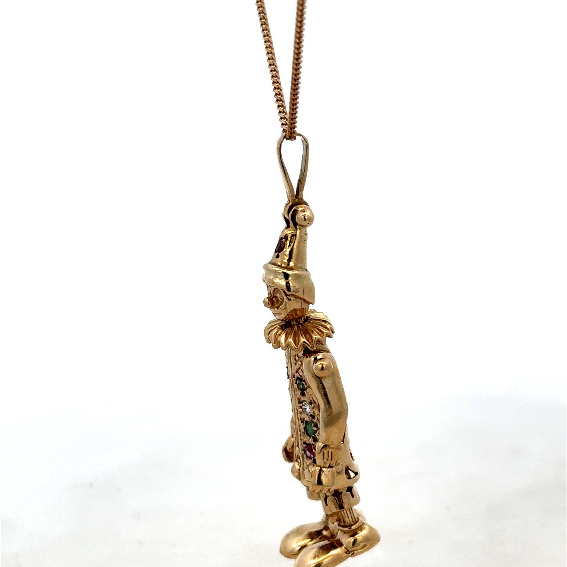 9ct yellow gold clown pendant with detailed face and colorful design, weighs 8.7g, by Reeves and Sons.