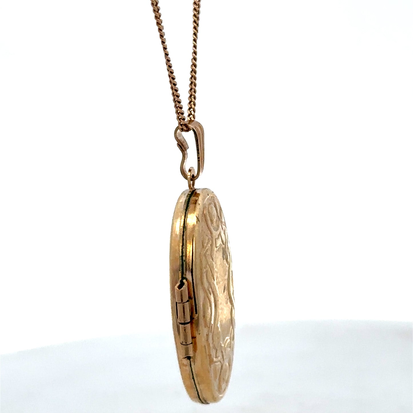 9ct yellow gold locket pendant by Reeves and Sons, 3.4g, featuring a smooth polished surface and classic rectangular shape.