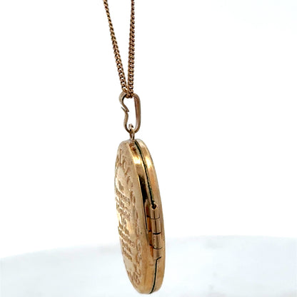 9ct yellow gold locket pendant by Reeves and Sons, showing detailed design and polished surface, weight 3.4g.