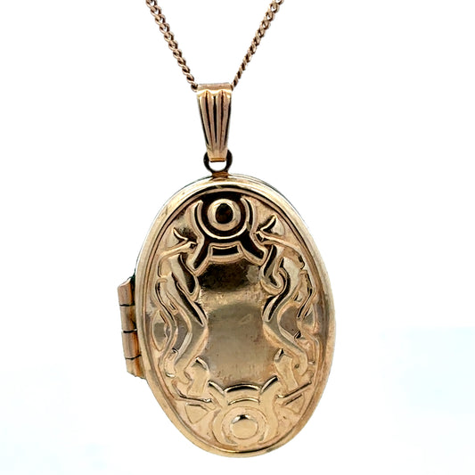 9ct yellow gold locket pendant with floral engraving, weighing 3.4g, from Reeves and Sons, shown close-up with detailed design.