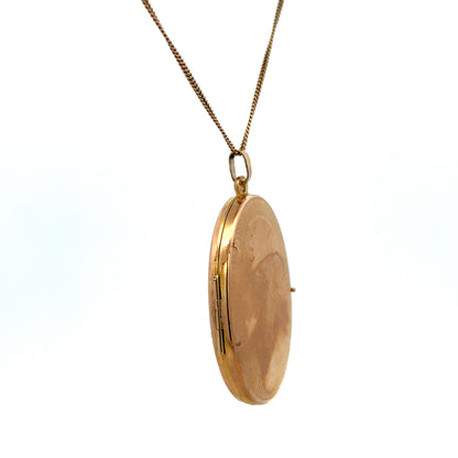 9ct yellow gold locket pendant by Reeves and Sons, showcasing a detailed, elegant design with a polished finish.