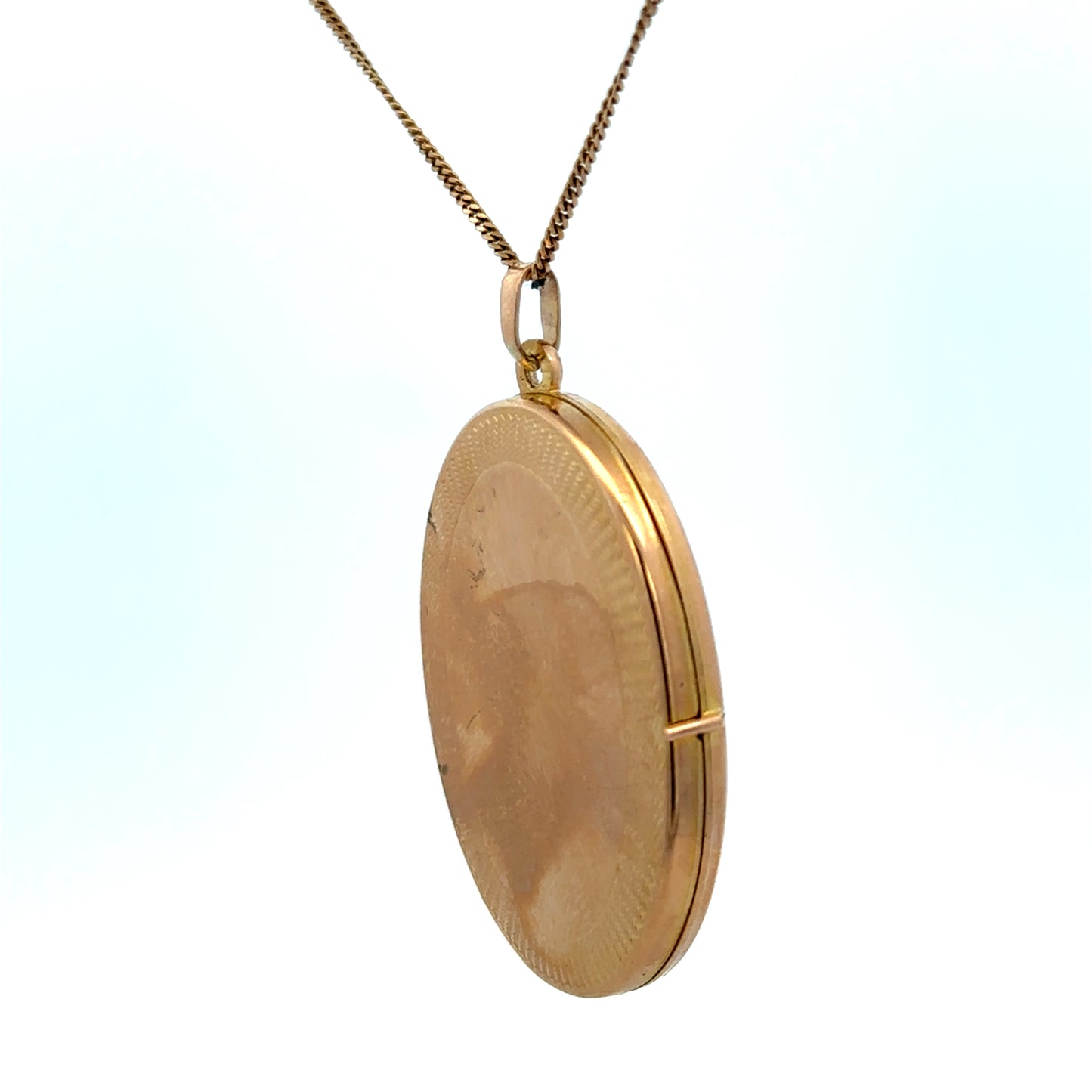 9ct yellow gold locket pendant by Reeves and Sons, featuring a polished, classic design with a secure bail for chain attachment.