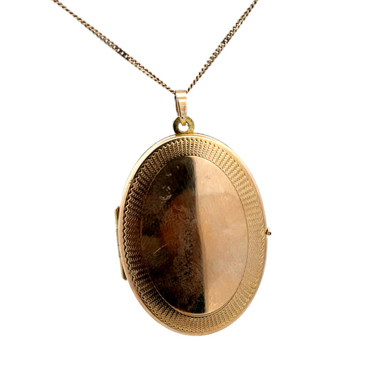 9ct yellow gold locket pendant by Reeves and Sons, weighing 6.7g, featuring a classic design with a polished finish.