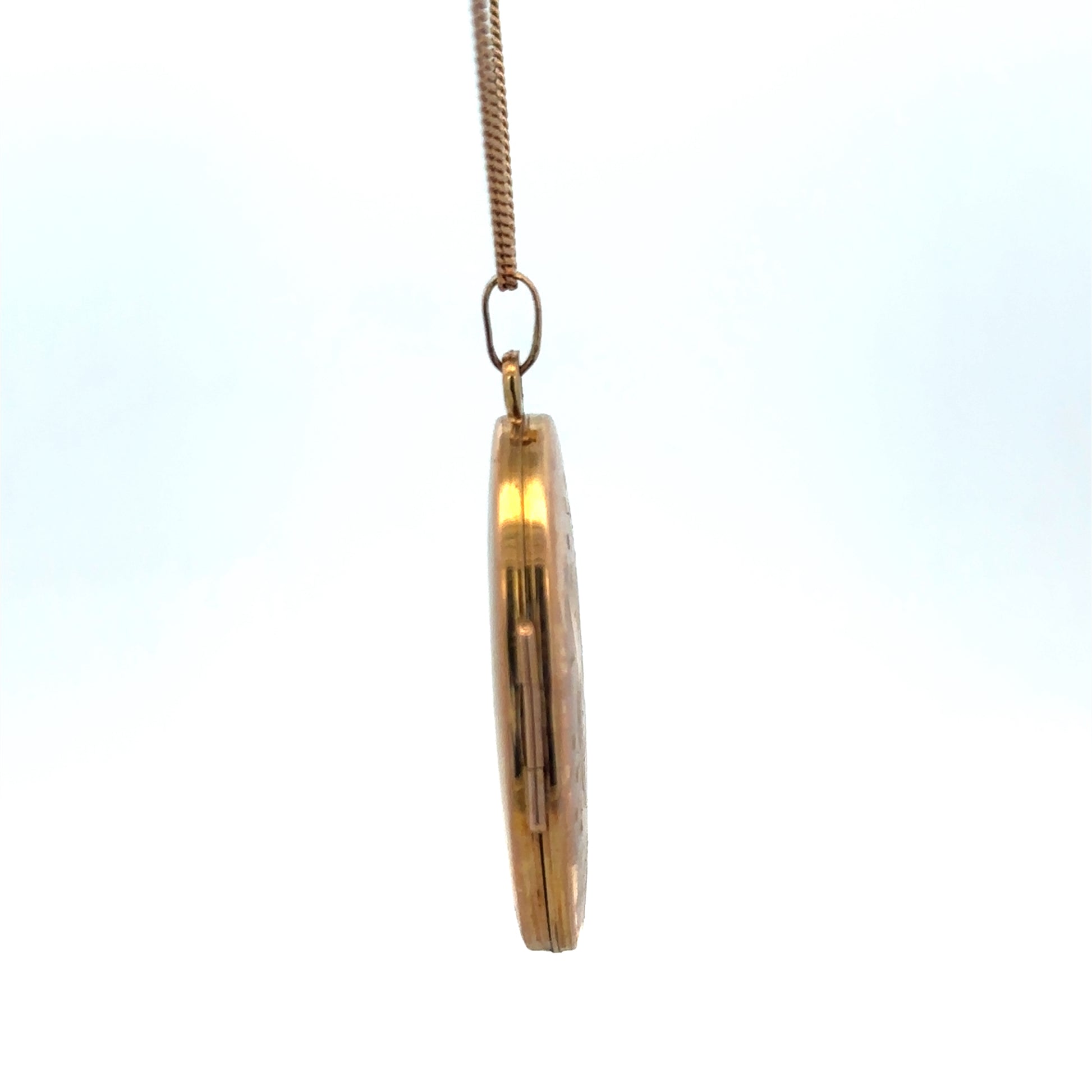 Reeves and Sons 9ct yellow gold locket pendant weighing 4.7g, featuring a classic oval design with intricate detailing.