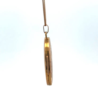 Reeves and Sons 9ct yellow gold locket pendant weighing 4.7g, featuring a classic oval design with intricate detailing.