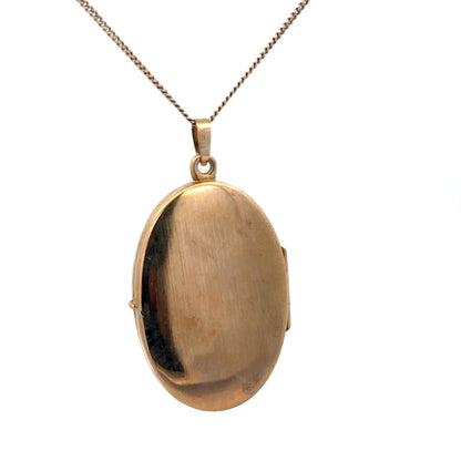 Yellow gold locket pendant by Reeves and Sons, 9ct, weighs 4.7g, featuring a classic design and intricate detailing.