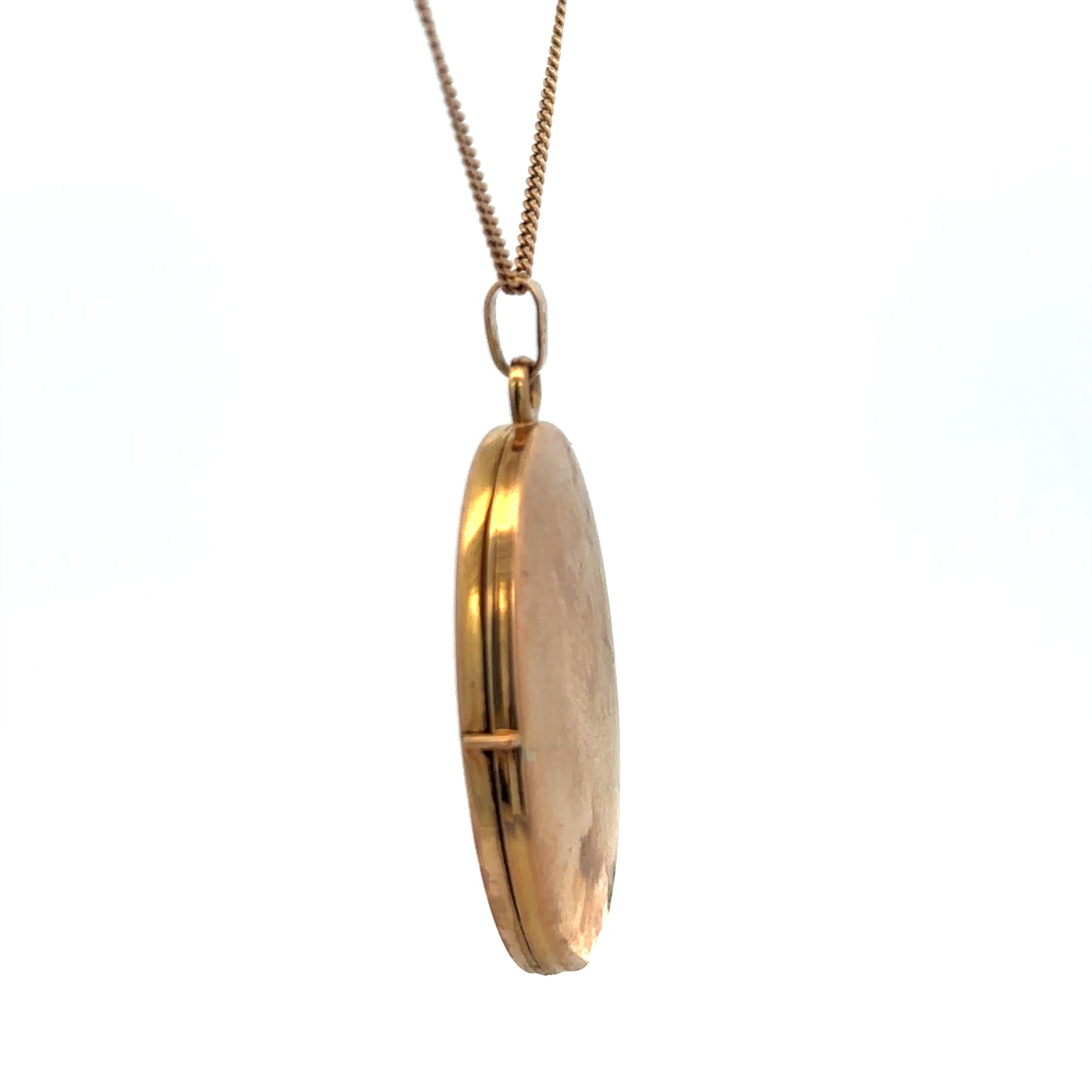 9ct yellow gold locket pendant by Reeves and Sons, 4.7g, featuring a polished smooth surface and classic design.
