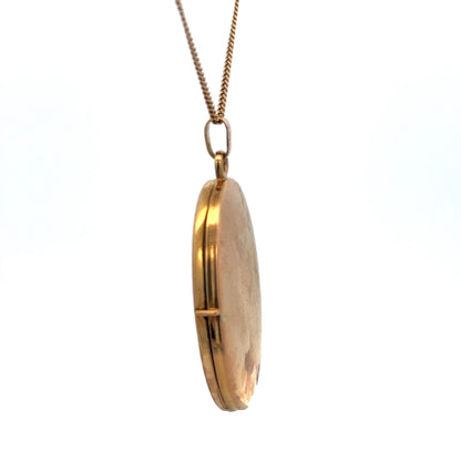 9ct yellow gold locket pendant by Reeves and Sons, 4.7g, featuring a polished smooth surface and classic design.