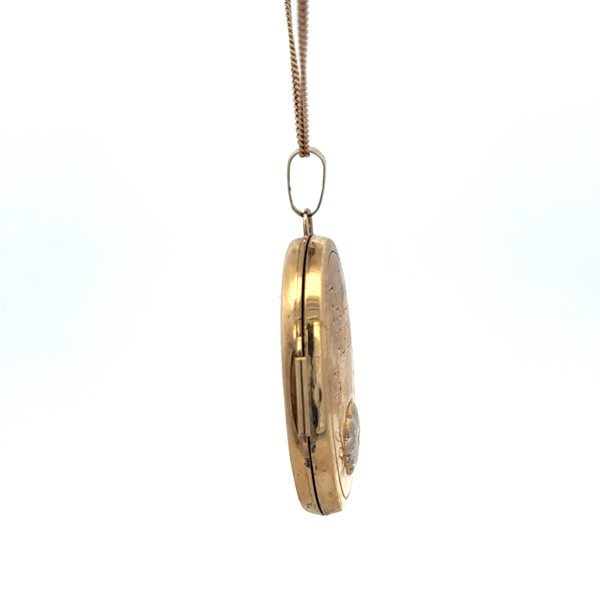 9ct yellow gold locket pendant with intricate design, weighing 5.8g, from Reeves and Sons, displayed on a plain background.