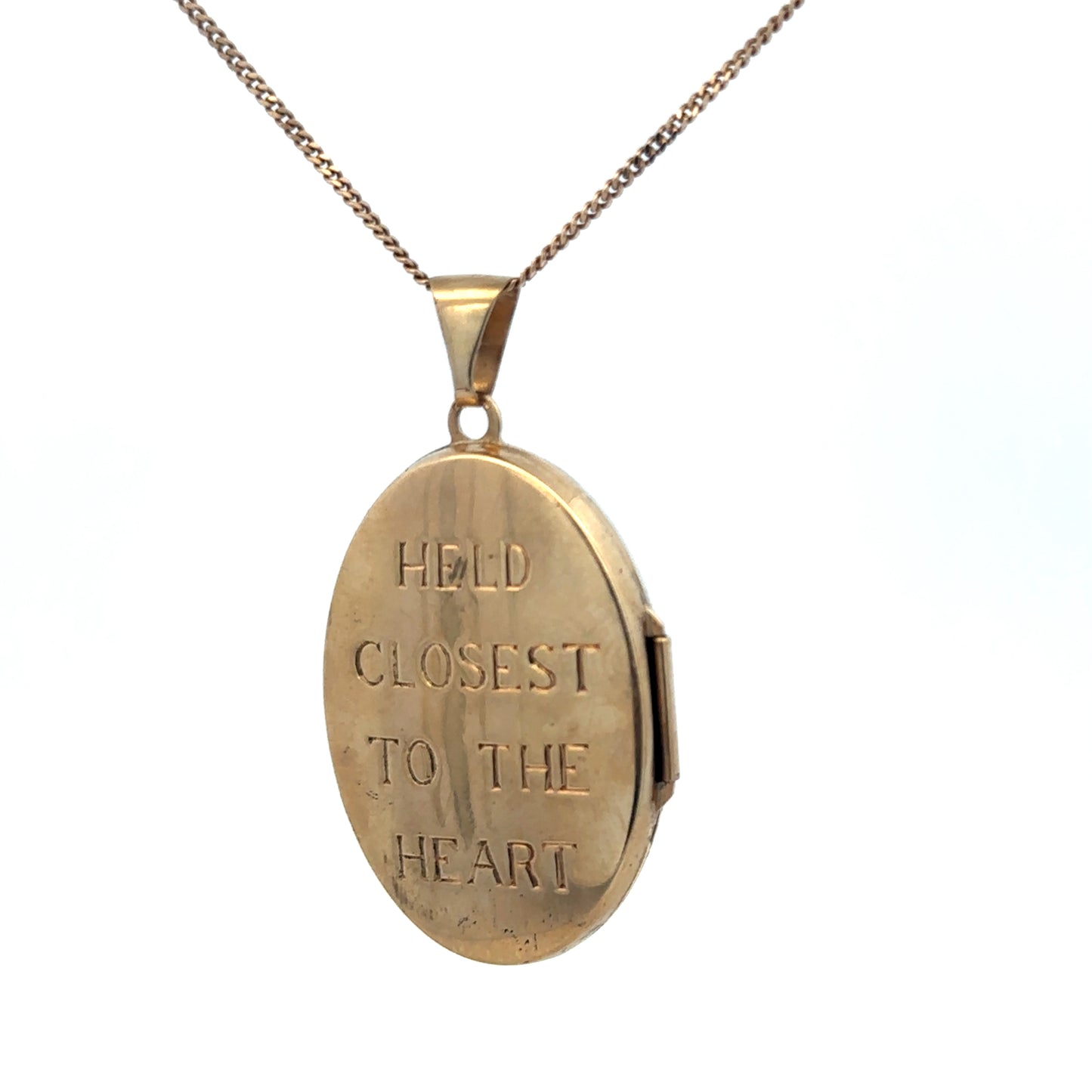 9ct yellow gold locket pendant with intricate detailing, weighing 5.8g, from Reeves and Sons.