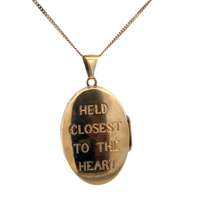 9ct yellow gold locket pendant with intricate design, weighing 5.8g, from Reeves and Sons, shown close-up.