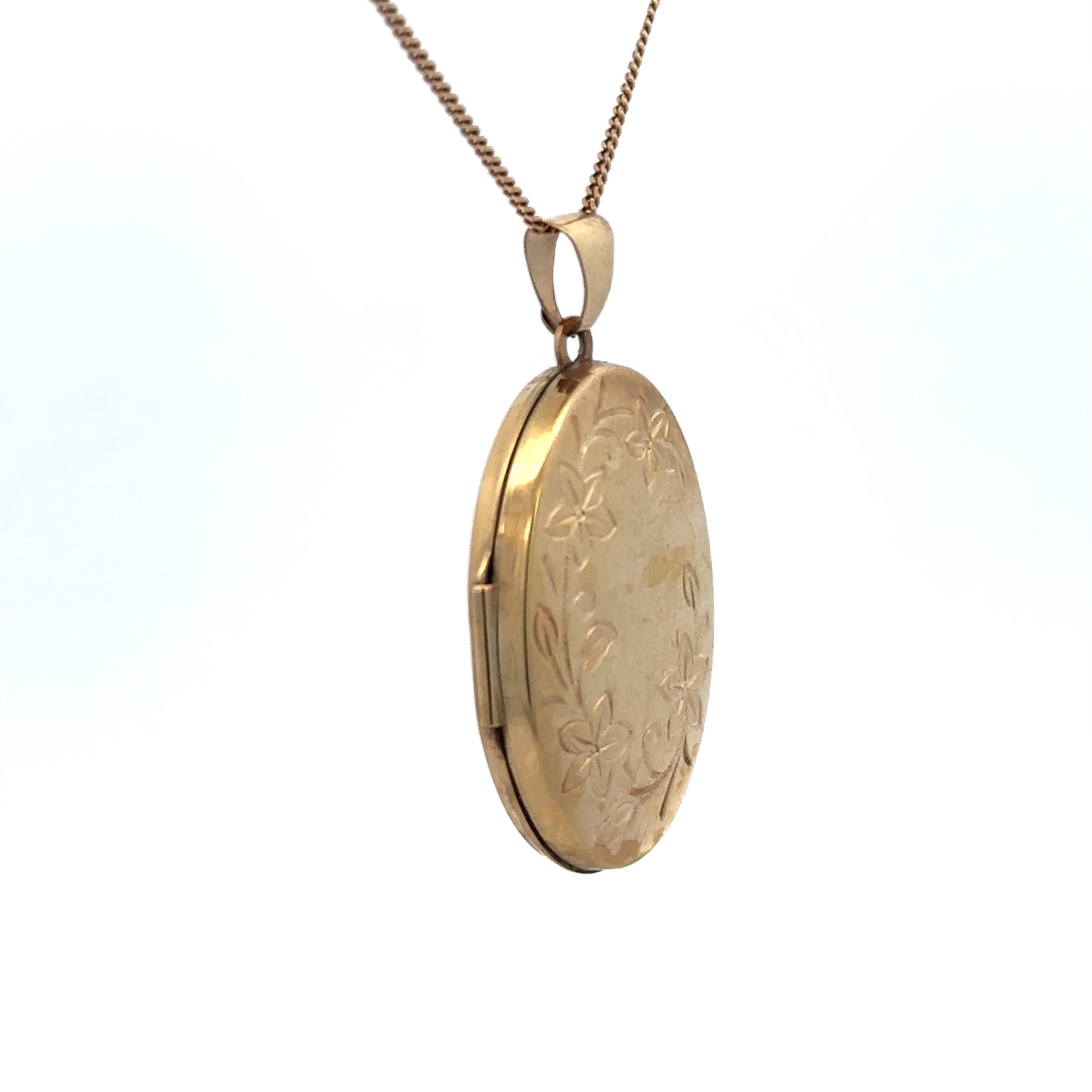 9ct yellow gold locket pendant with engraved design, weighing 4.2g, by Reeves and Sons, shown with intricate detailing.