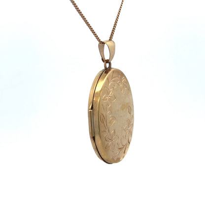 9ct yellow gold locket pendant with engraved design, weighing 4.2g, by Reeves and Sons, shown with intricate detailing.
