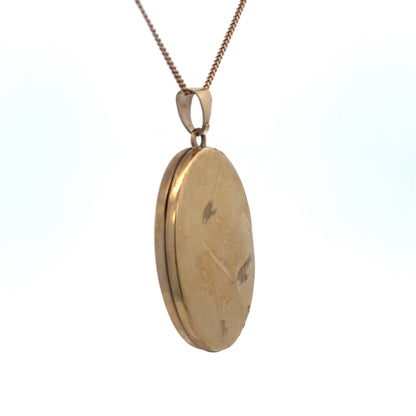 9ct yellow gold locket pendant by Reeves and Sons, featuring intricate design, weighs 4.2g, and is shown close-up.